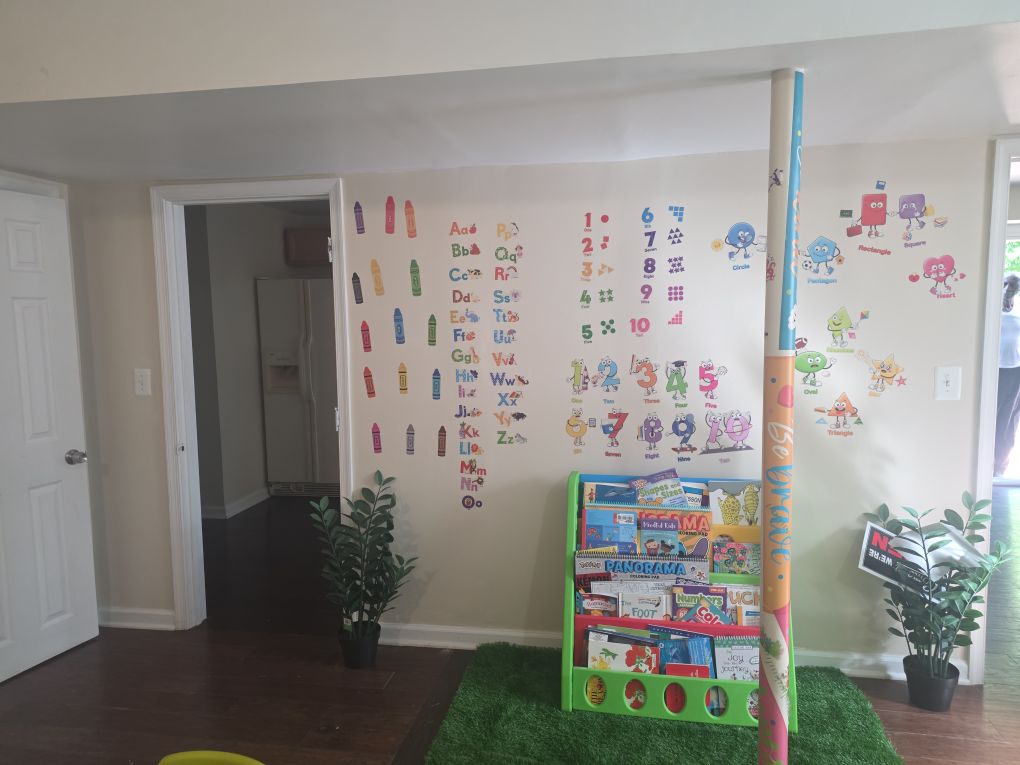 Play area with toys and dino wall